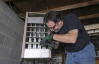 Technician repairing furnace