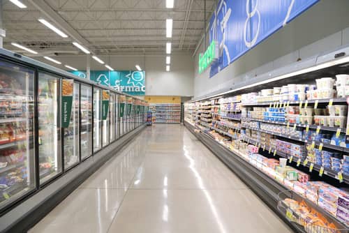 Picture of a grocery store aisle with refrigeration coolers and freezers